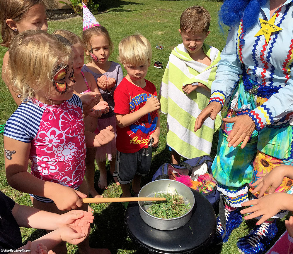 Kids doing magic to a pan of grass