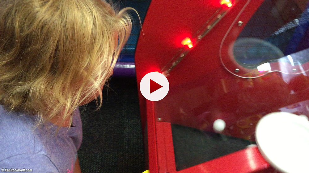 Ryan and Katie play the popcorn catching game at chuck e cheeses