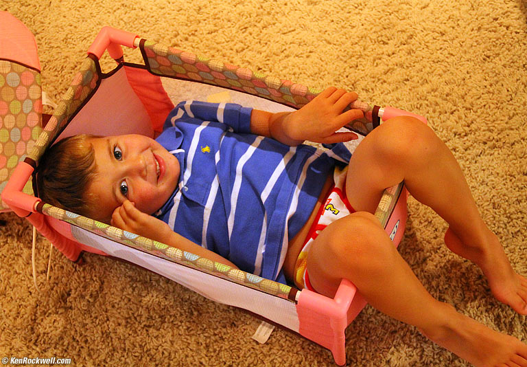 Ryan in Katie's baby's (toy) crib.