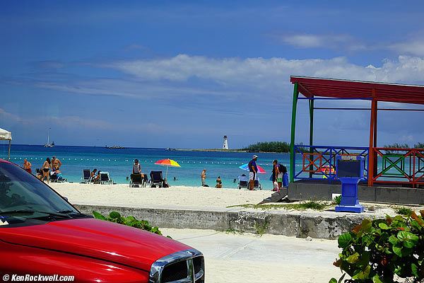 Bahamas beach, colorful umbrella and lighthouse