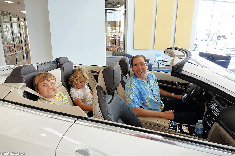 Dad and kids in an E400 convertible