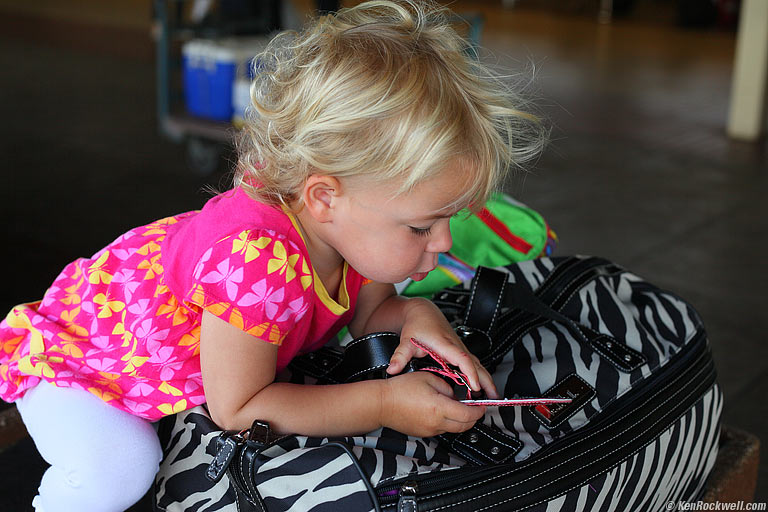 Katie checks out mom's luggage tags, Maui. 8:39 AM.