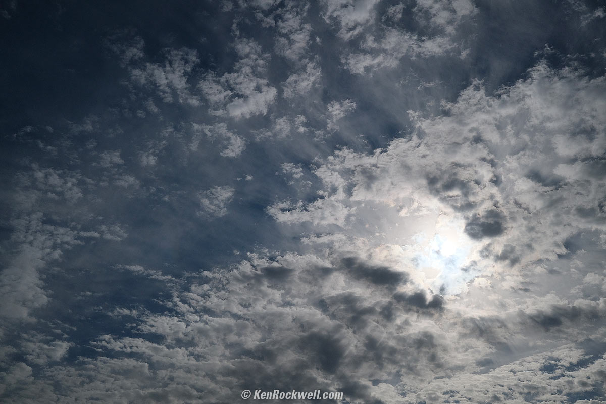 Sun and many clouds
