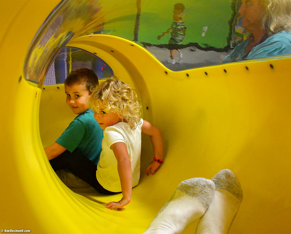 Ryan, Katie and Dada sliding down the slide