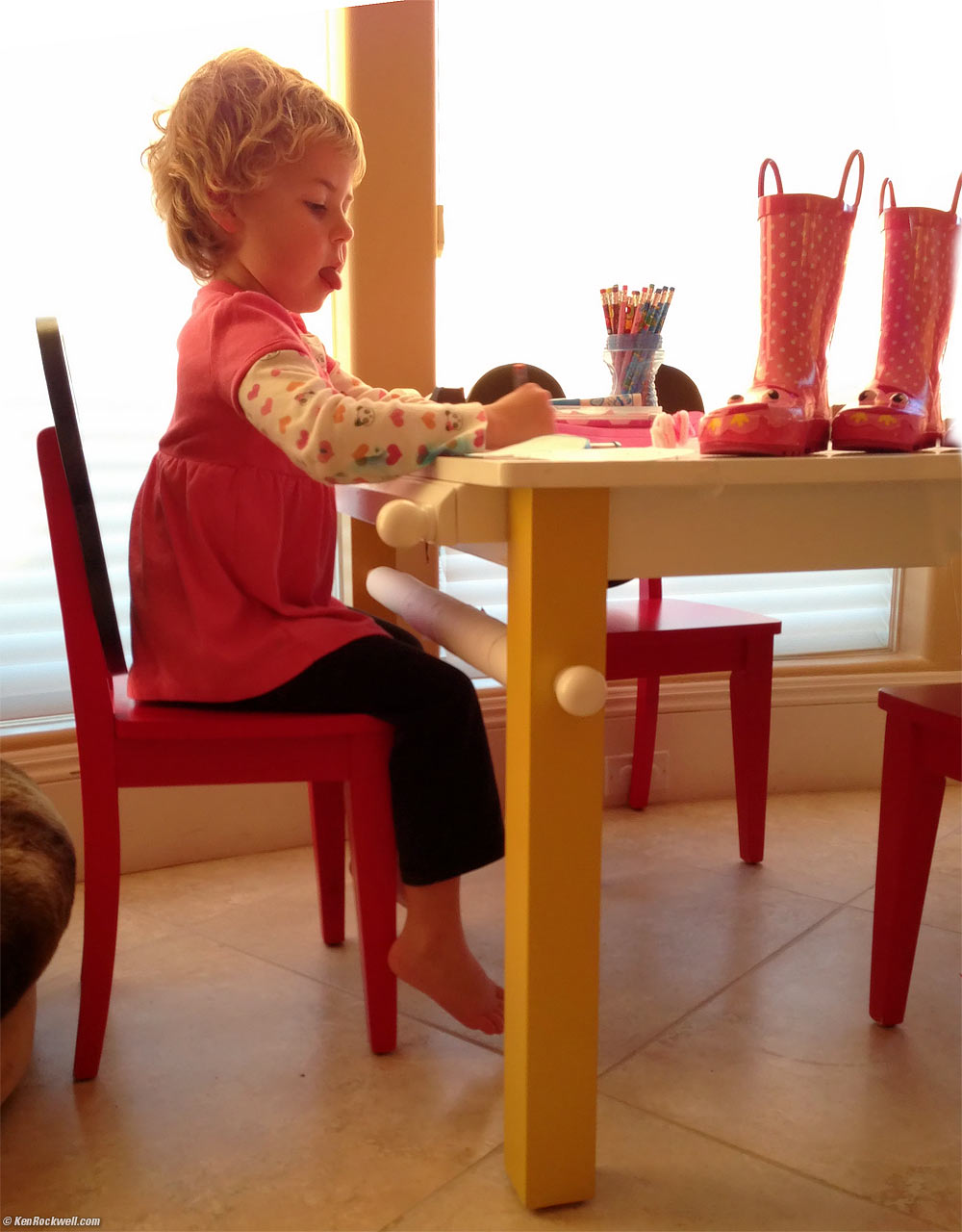 Katie coloring Dada's hand, as well as her own.