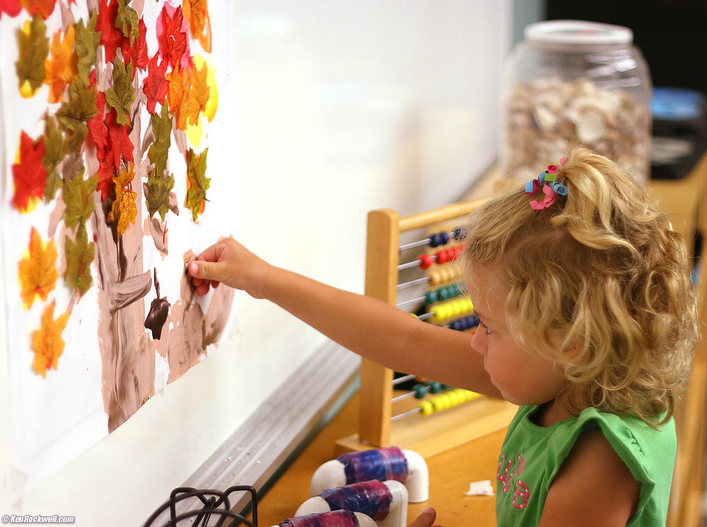 Katie attaches just the right eye to the squirrel she painted yesterday in Miss Kim's Art Class.