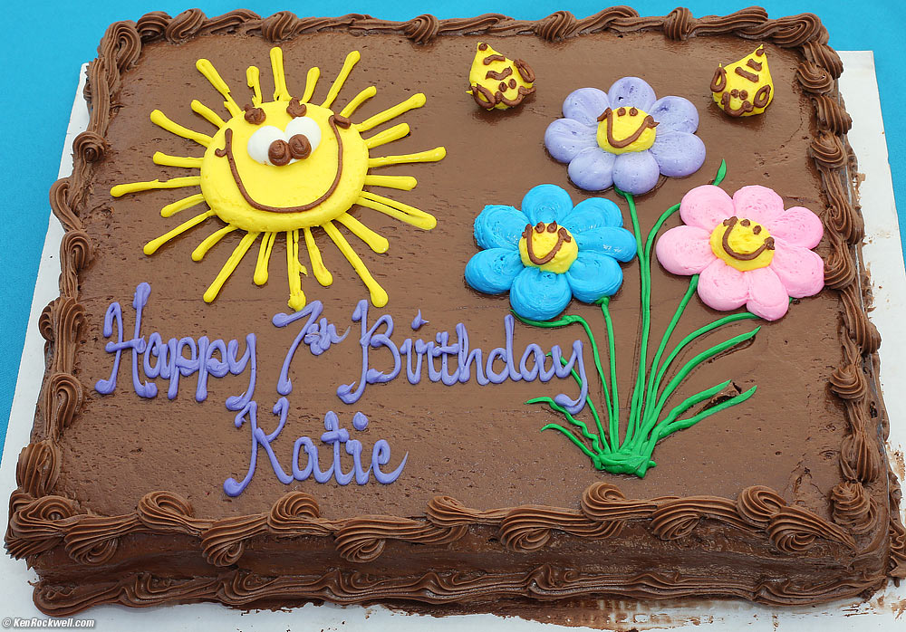 Brown birthday cake with smiley sun