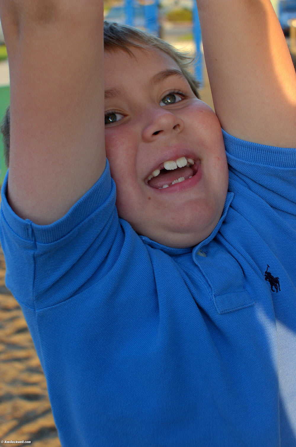 Ryan swings on the gliding handle at the park.