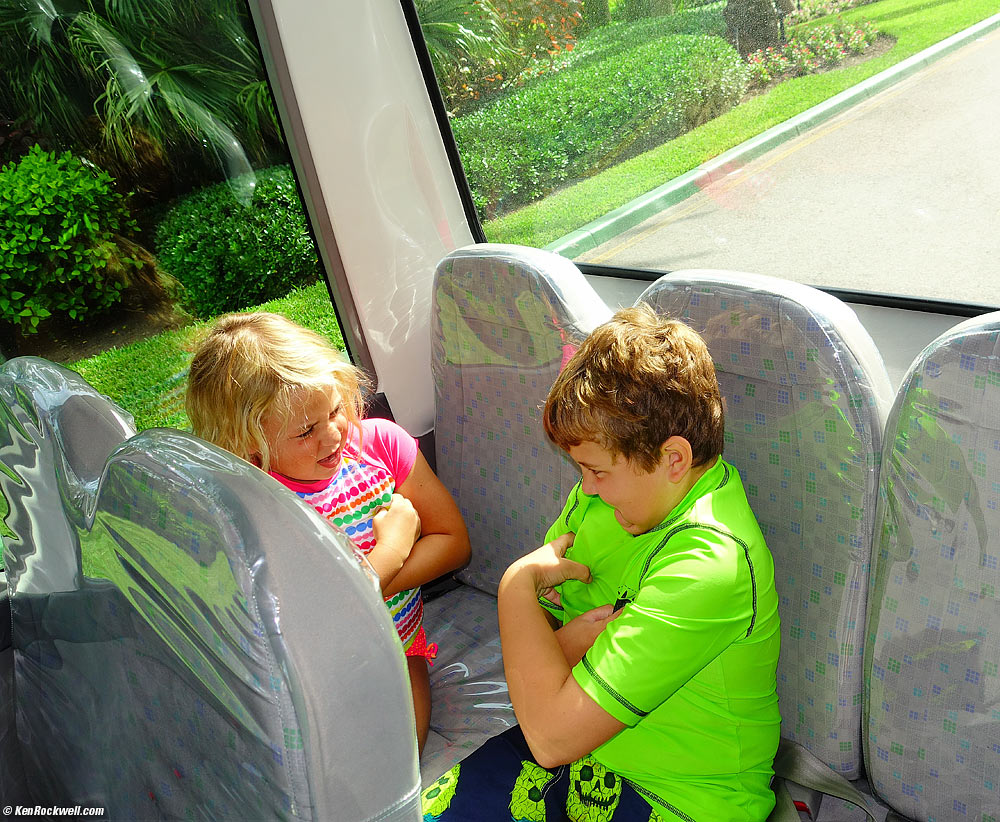 Kids playing in the back of the shuttle bus