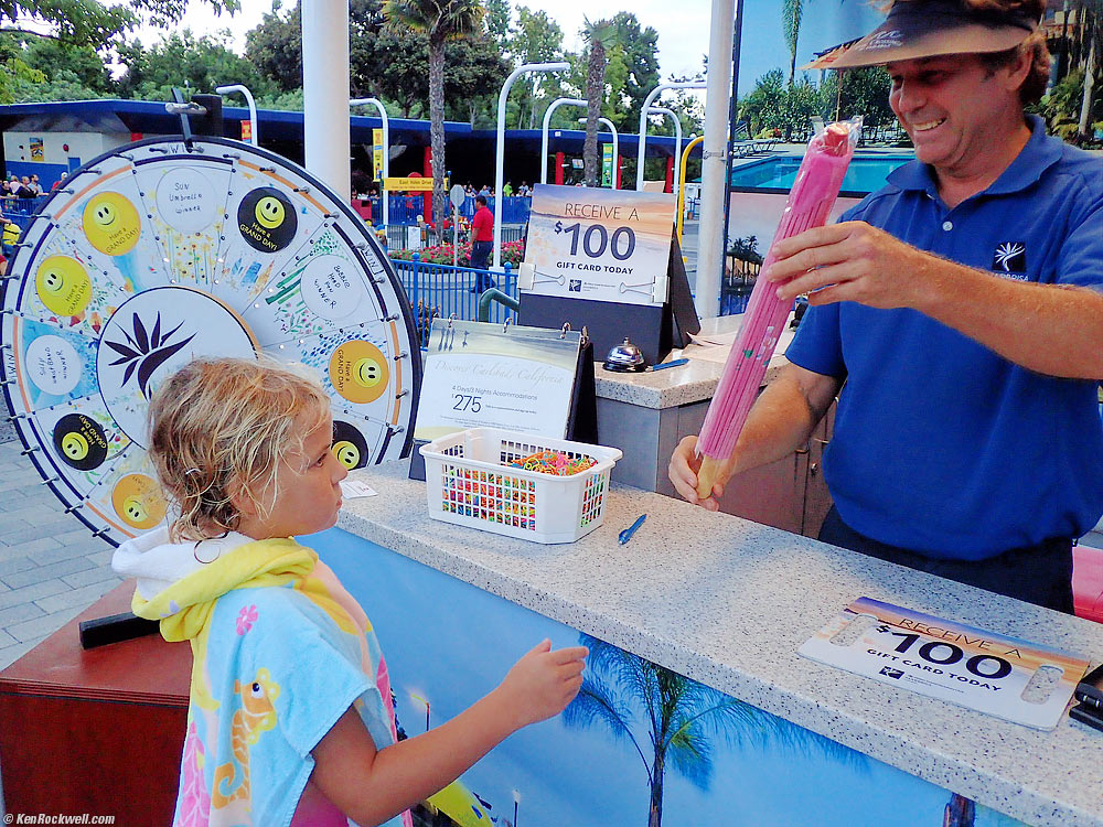 Katie wins a pink sun umbrella from a timeshare huckster