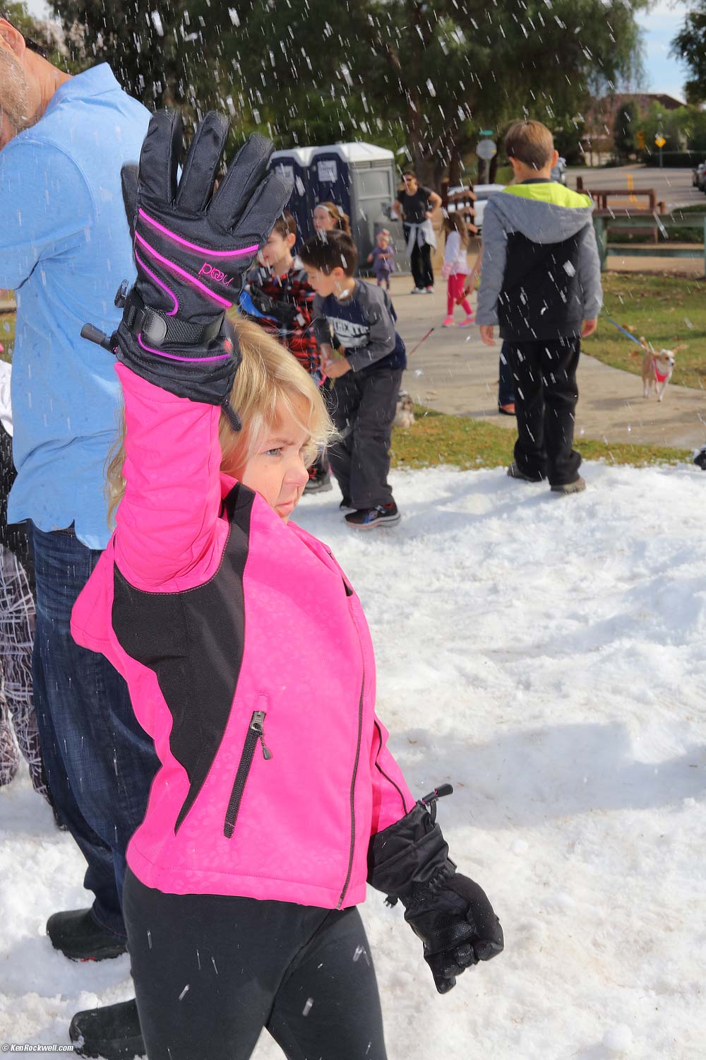 Katie sprays snow. 
