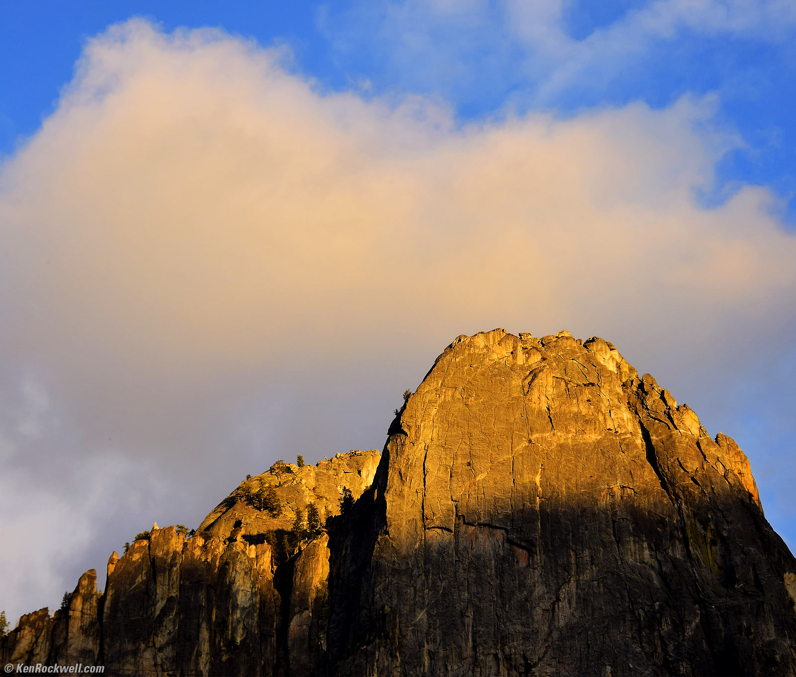 Gold Mountain in last light against Blue sky with same-shaped cloud